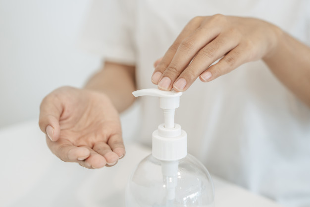 A woman taking out hand sanitizer to clean her hands during the COVID-19 crisis