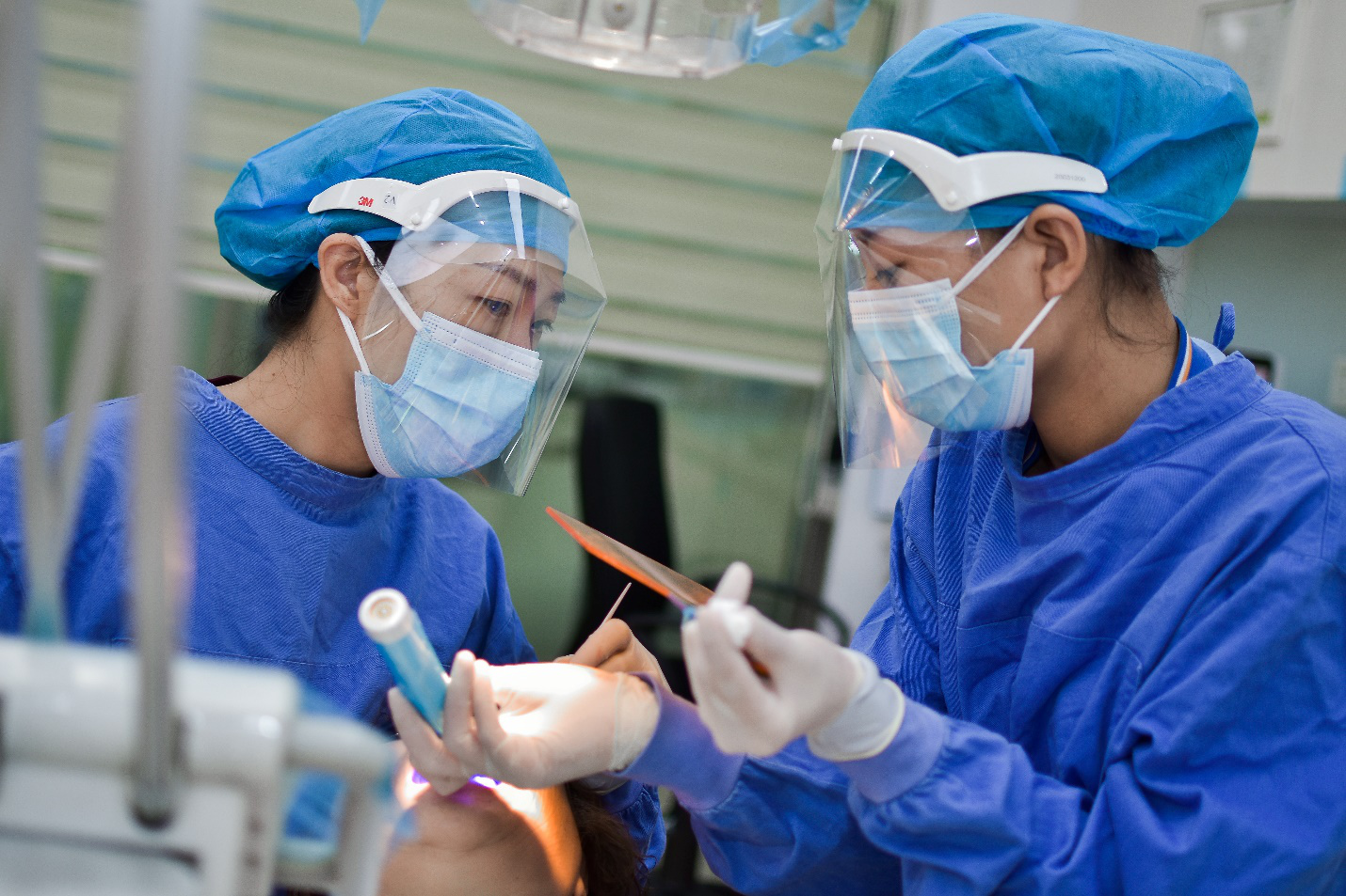 Surgeons wearing PPE while working